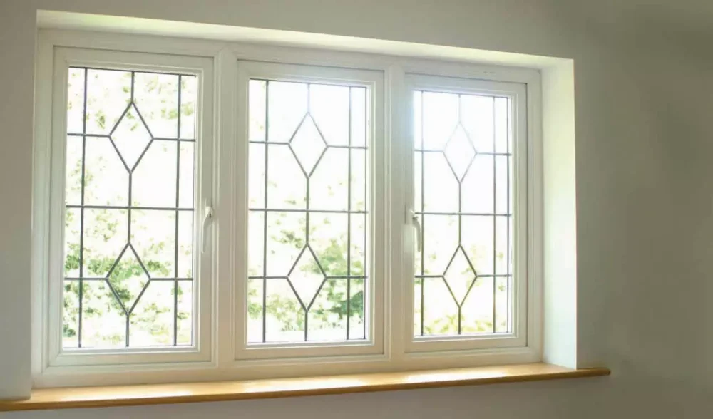 White uPVC windows with decorative leaded glazing viewed from inside a room