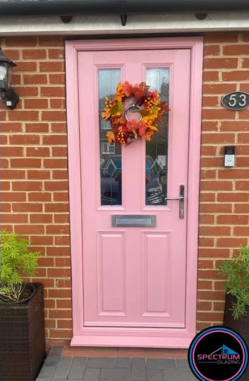 After installation: pink Apeer 70 composite front door with chrome furniture and seasonal wreath