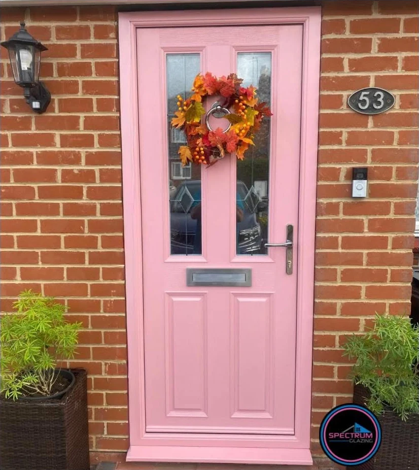 Pink Apeer 70 composite front door with chrome furniture and an autumn wreath, installed by Spectrum Glazing in Hatfield Peverel